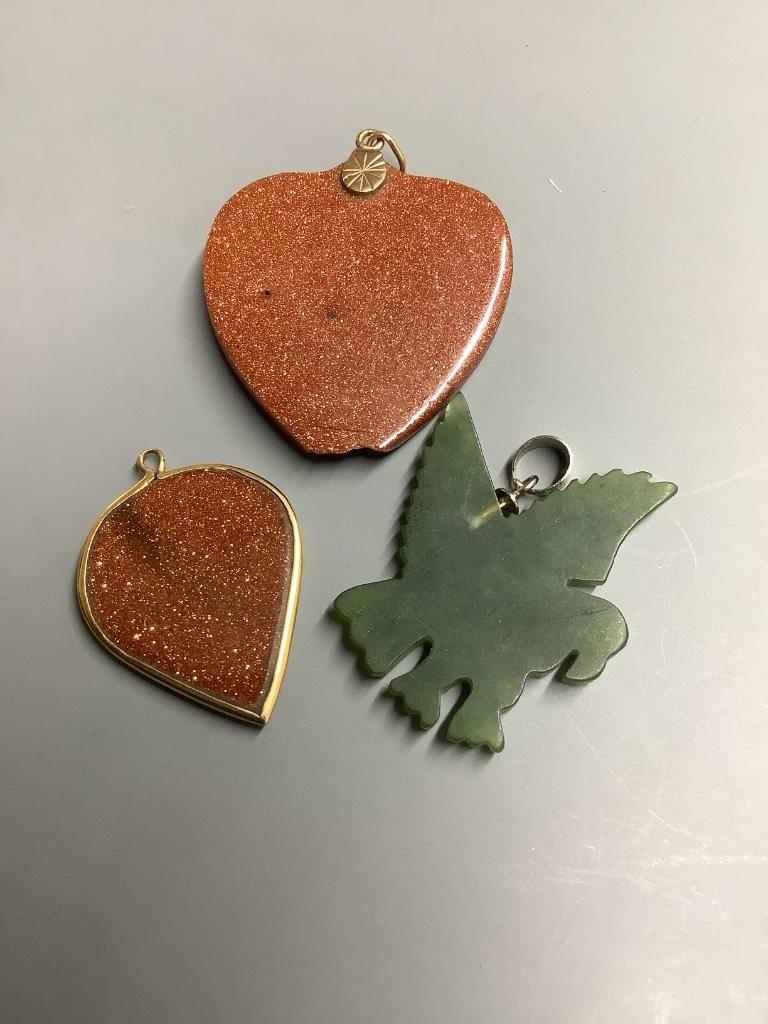 Two adventurine glass pendants, one a.f. and one other carved hardstone pendant.